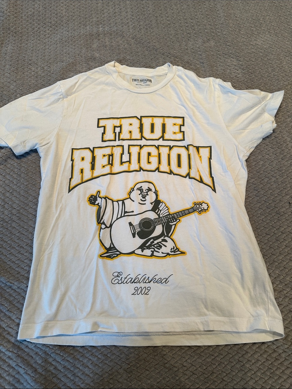 True Religion White Short Sleeve Tee with Yellow-Outlined Logo and guitar Buddha